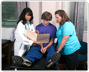 doctor shows mother and son file in office