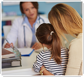 doctor talking to mother and young girl