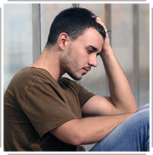 young man depressed with head in hand