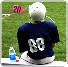 sitting on sidelines of football game