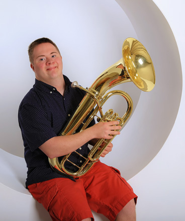 Young man holding a baratone instument.